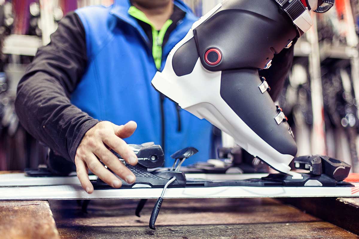 A team member fits a boot to a ski.